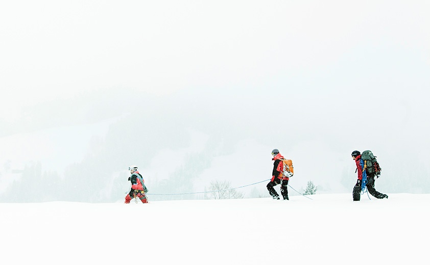two hikers with ski gear and backpack in snow