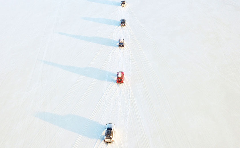 Suv driving on salt flat