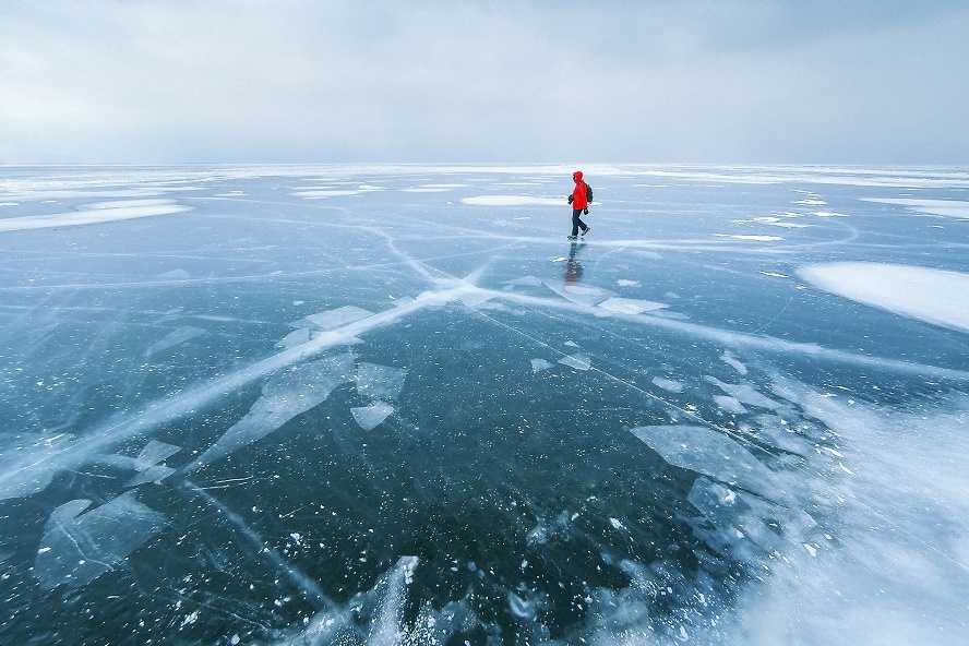 man walking across frozen lake, Apostle Islands, Wisconsin, America, USA