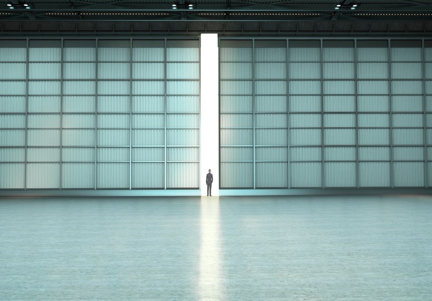 a man standing in front of the hangar doors.